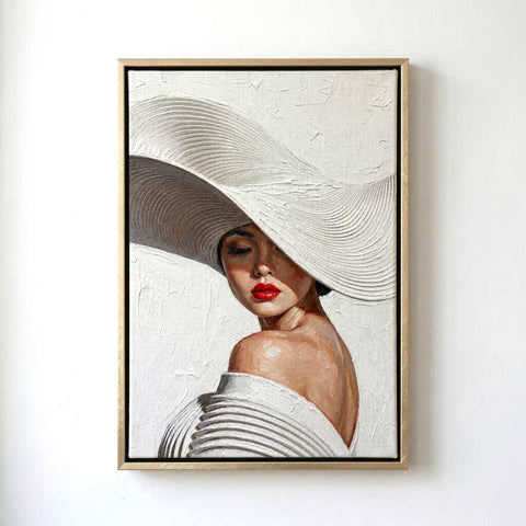 A framed portrait painting of a woman wearing a large white hat and an off-the-shoulder white dress, with textured brushstrokes and a light wood frame on a white wall.