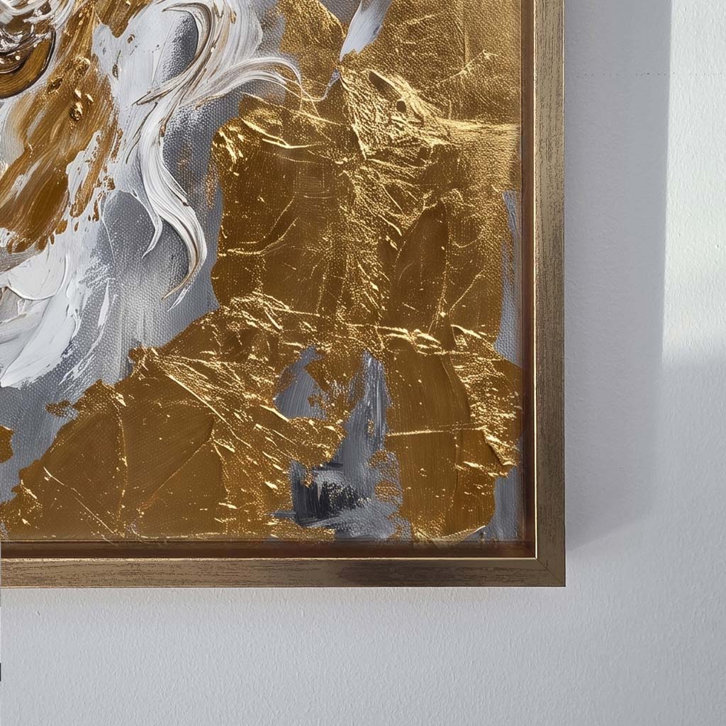 Close-up of a framed abstract wall art piece with textured gold, white, and gray brushstrokes, shown against a light gray wall.